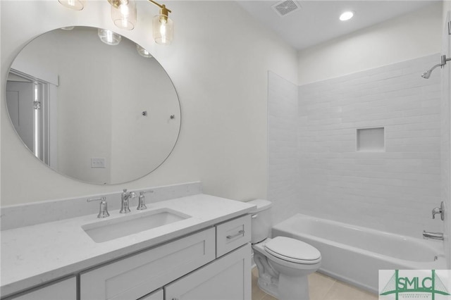 full bathroom featuring tiled shower / bath, tile patterned flooring, vanity, and toilet