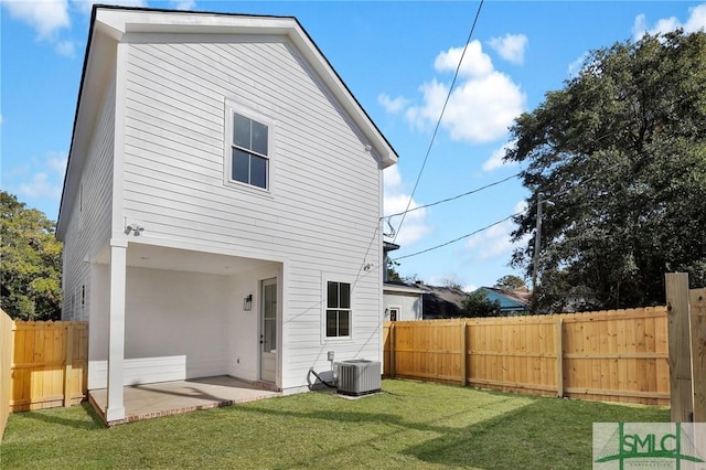 rear view of property with a patio area, a yard, and central air condition unit