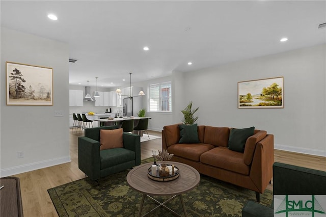 living room with light hardwood / wood-style flooring