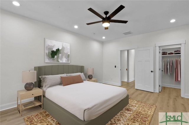 bedroom with ceiling fan, light hardwood / wood-style flooring, and a closet