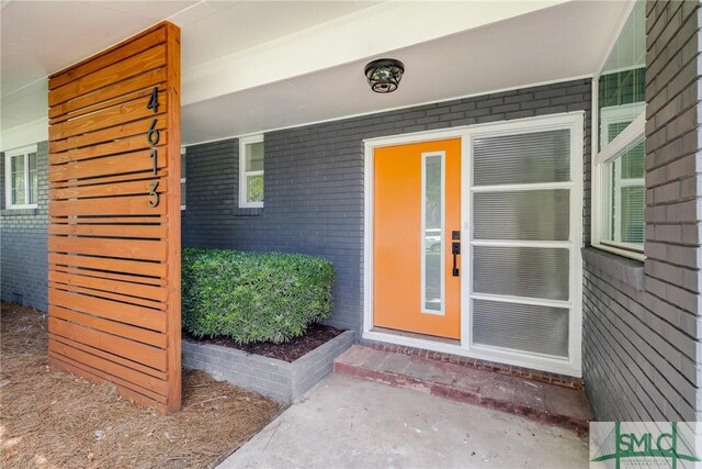 view of exterior entry with covered porch