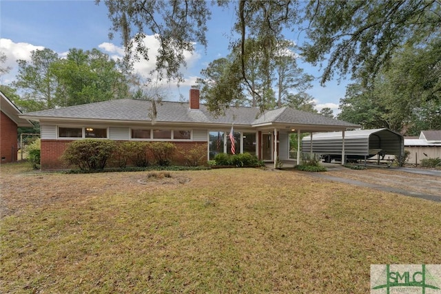 ranch-style home featuring covered porch, a carport, and a front lawn