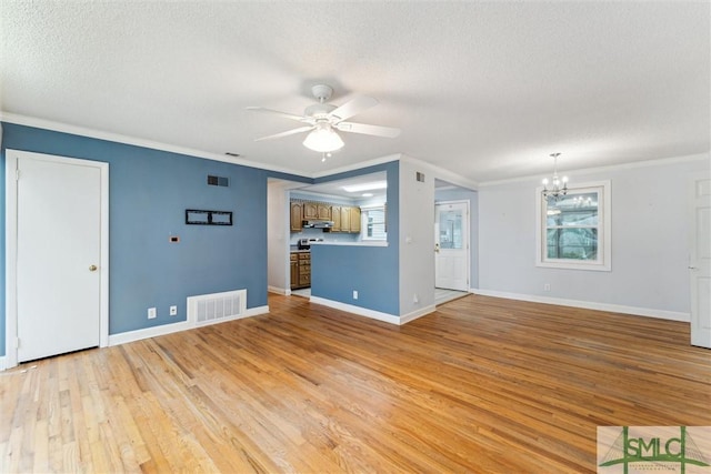 unfurnished living room with a textured ceiling, ceiling fan with notable chandelier, light wood-type flooring, and crown molding