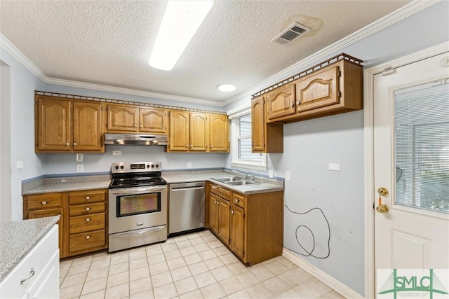 kitchen with sink, ornamental molding, a textured ceiling, and appliances with stainless steel finishes