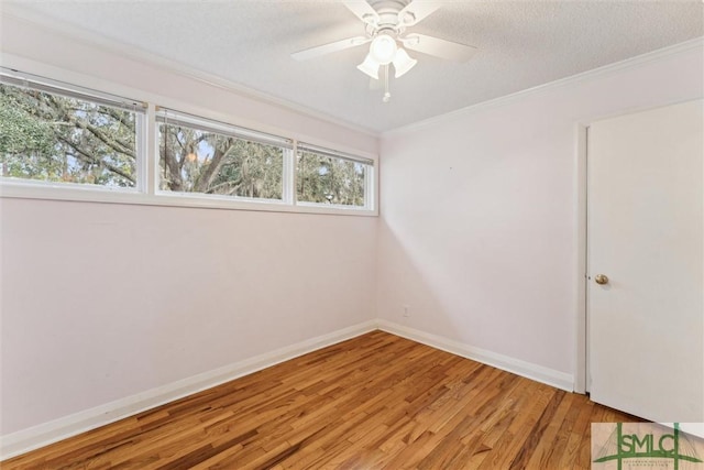 spare room featuring ceiling fan, light hardwood / wood-style floors, crown molding, and a textured ceiling