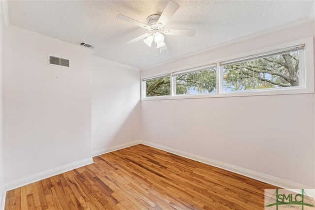 unfurnished room featuring a textured ceiling, hardwood / wood-style flooring, ceiling fan, and crown molding