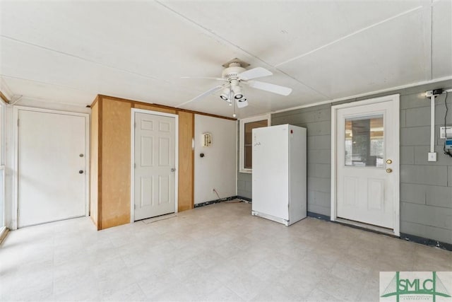 interior space with ceiling fan and white refrigerator