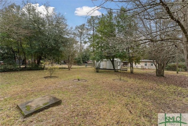 view of yard featuring a storage unit