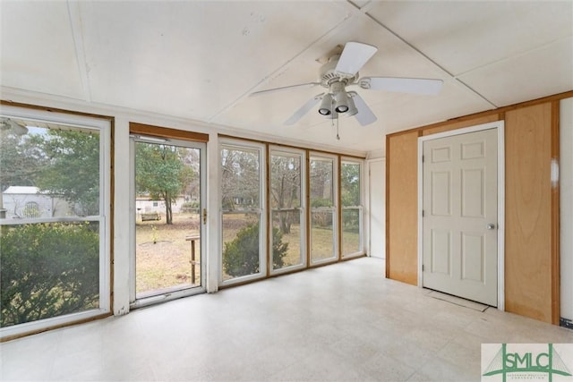 unfurnished sunroom with ceiling fan