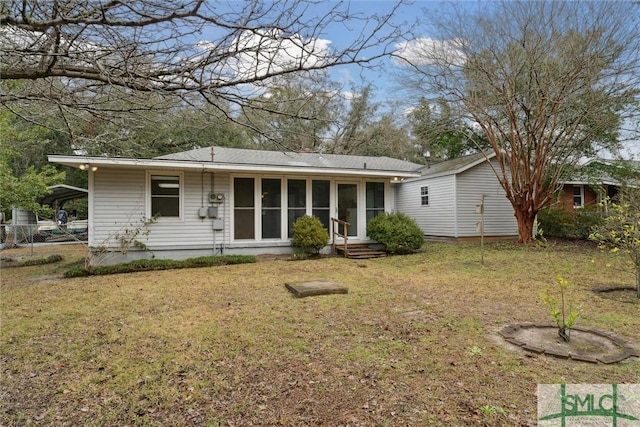 back of house featuring a sunroom and a yard