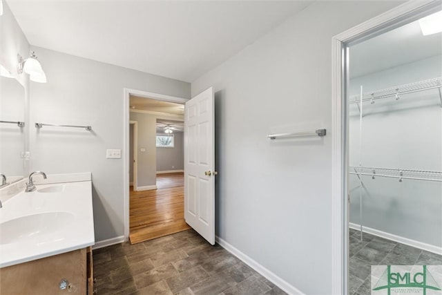 bathroom featuring ceiling fan and vanity