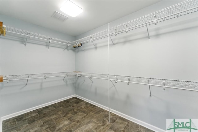 walk in closet featuring dark hardwood / wood-style floors