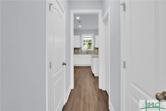 hallway with sink and dark wood-type flooring