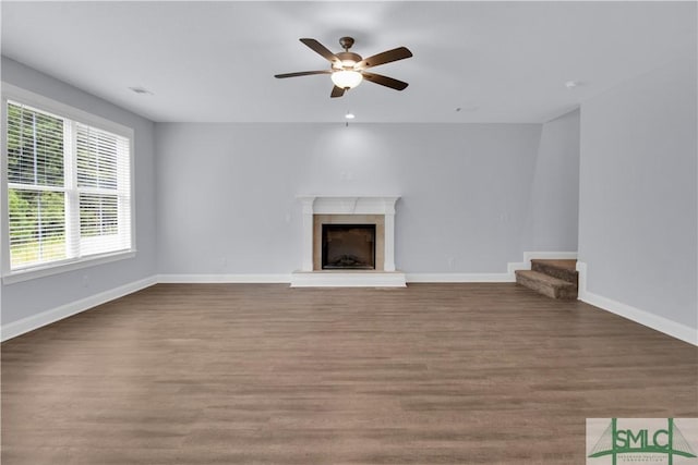 unfurnished living room with ceiling fan and wood-type flooring