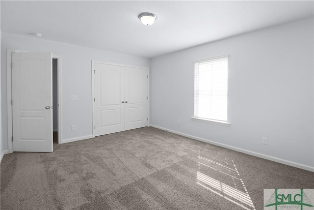 unfurnished bedroom with carpet flooring and a closet