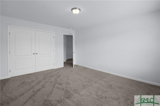 unfurnished bedroom with carpet and a closet