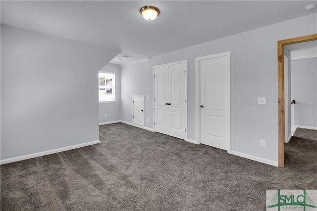 additional living space with dark colored carpet