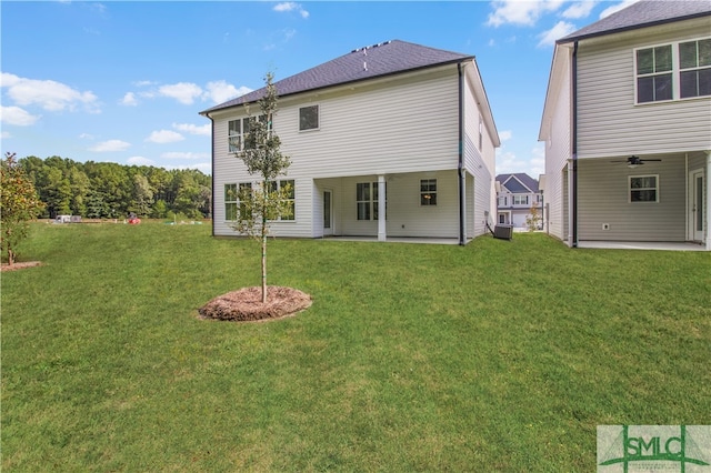 back of house with central air condition unit, a patio area, and a yard