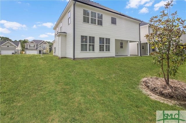 rear view of property with a lawn