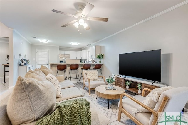 living room featuring ceiling fan and ornamental molding