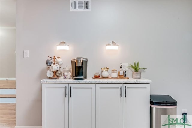 bar with white cabinetry