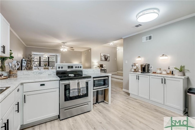 kitchen with crown molding, light hardwood / wood-style flooring, ceiling fan, appliances with stainless steel finishes, and white cabinetry