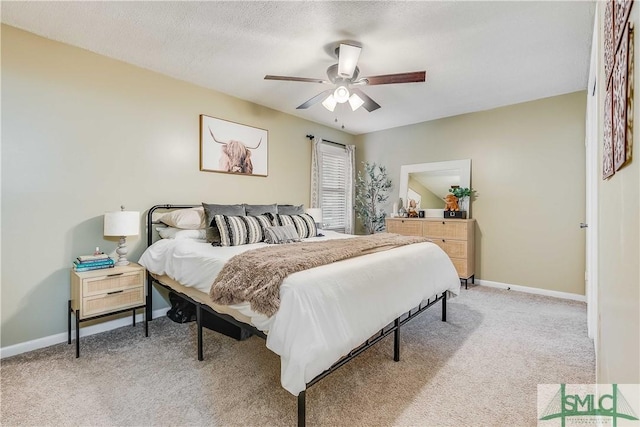 carpeted bedroom with a textured ceiling and ceiling fan