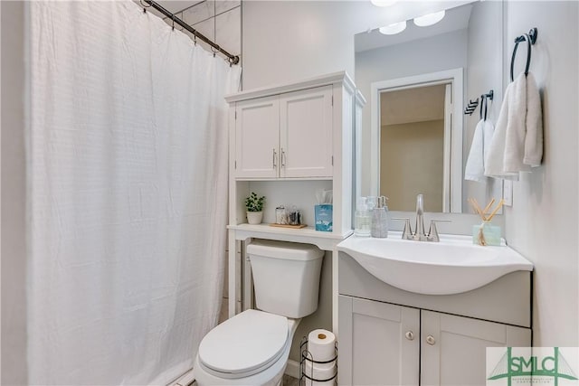 bathroom featuring vanity and toilet