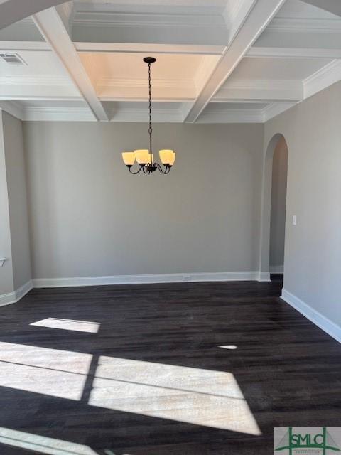 unfurnished room with coffered ceiling, dark wood-type flooring, crown molding, beam ceiling, and an inviting chandelier