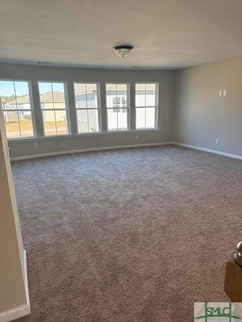 empty room with dark colored carpet