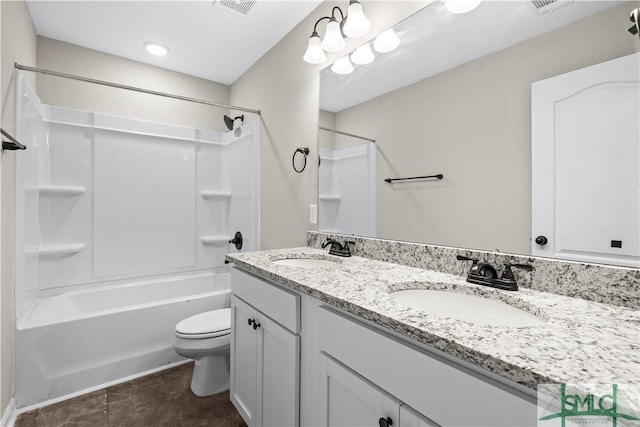 bathroom featuring tile patterned floors, tub / shower combination, toilet, and a sink