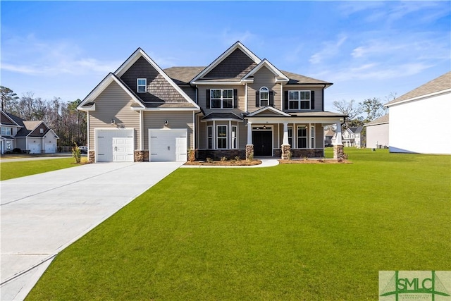 craftsman-style home featuring a front yard, an attached garage, covered porch, concrete driveway, and stone siding