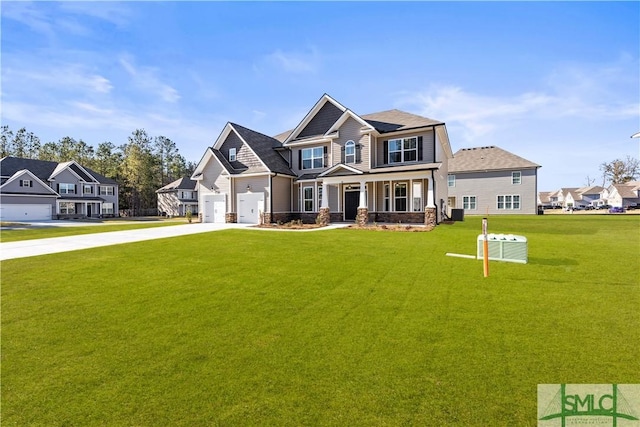 craftsman-style house featuring a residential view, a front yard, covered porch, a garage, and driveway