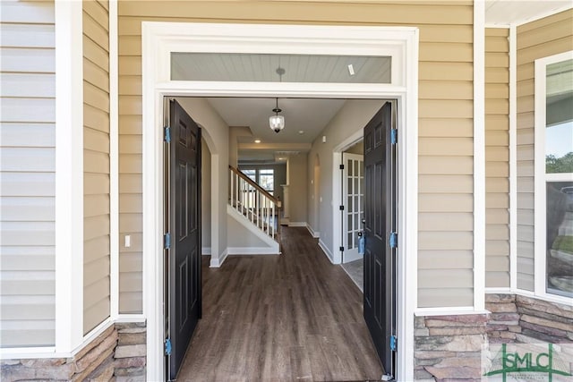 property entrance featuring stone siding