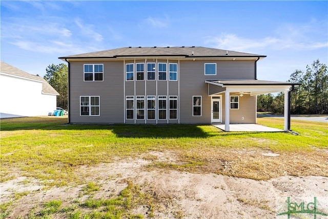 rear view of property with a patio area and a lawn