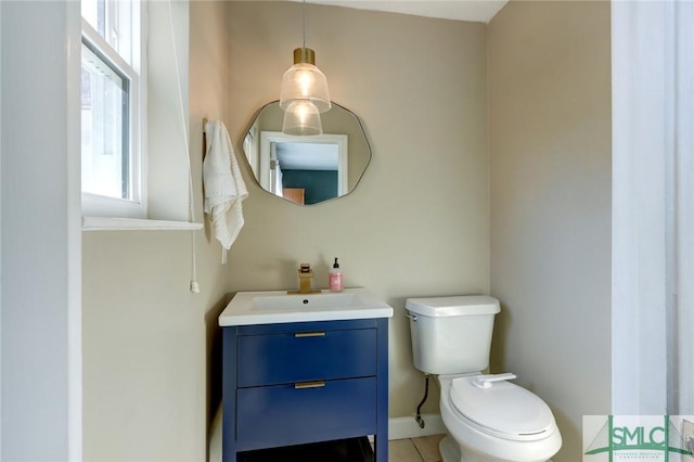 bathroom featuring tile patterned floors, vanity, and toilet