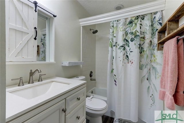 full bathroom featuring vanity, toilet, a textured ceiling, and shower / tub combo