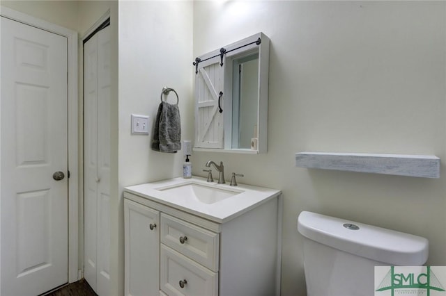 bathroom with vanity and toilet