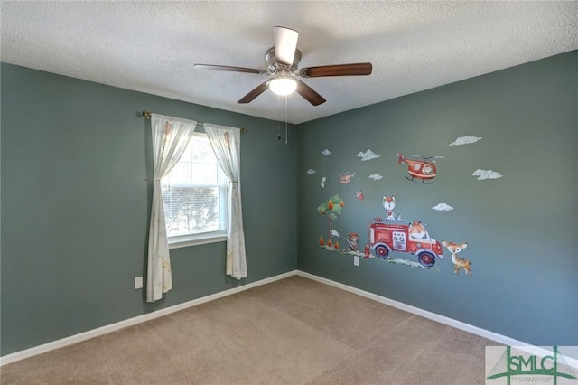 empty room with carpet, a textured ceiling, and ceiling fan