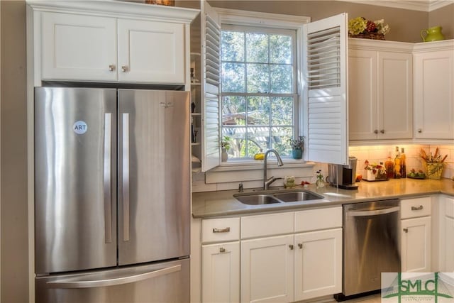 kitchen with white cabinetry, sink, appliances with stainless steel finishes, and tasteful backsplash