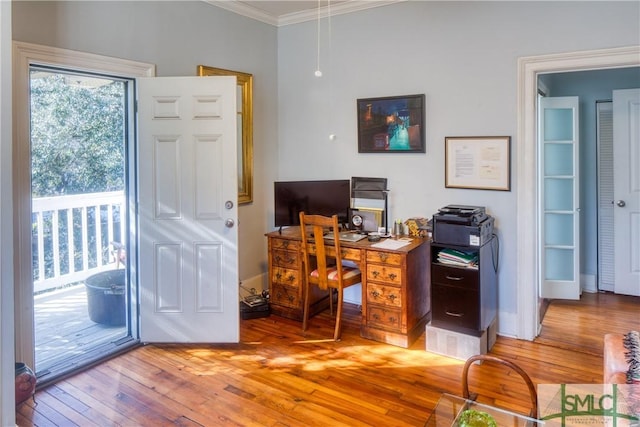 office with crown molding and light hardwood / wood-style flooring