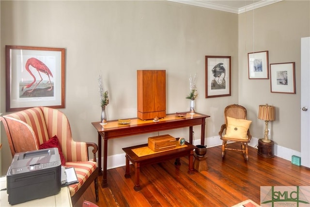 sitting room with dark wood-type flooring and ornamental molding