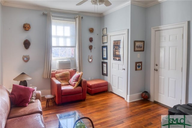 living room with hardwood / wood-style flooring, ceiling fan, and crown molding