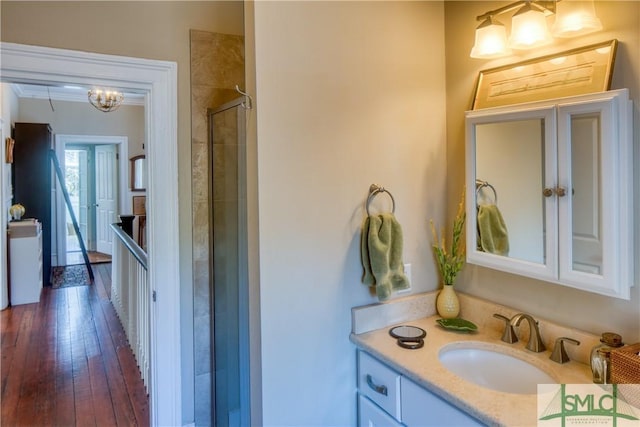 bathroom featuring a shower with door, vanity, and hardwood / wood-style floors