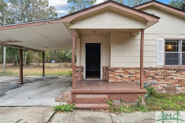 doorway to property featuring a carport