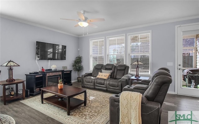 living room featuring dark hardwood / wood-style floors, ceiling fan, and ornamental molding