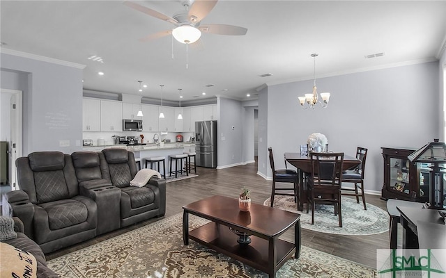 living room featuring crown molding, sink, dark wood-type flooring, and ceiling fan with notable chandelier