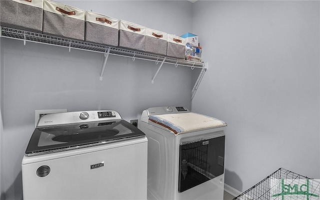 laundry area with independent washer and dryer