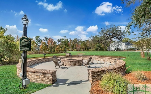 view of property's community featuring a fire pit, a patio area, and a yard