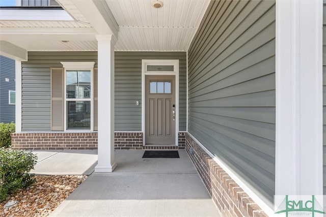 property entrance featuring brick siding